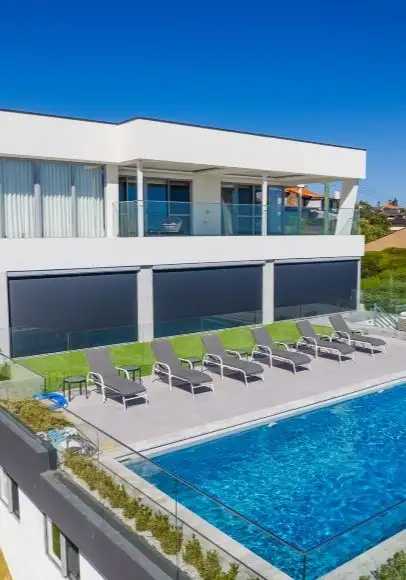 Ziptrak blinds along the pool terrace of a City Beach home