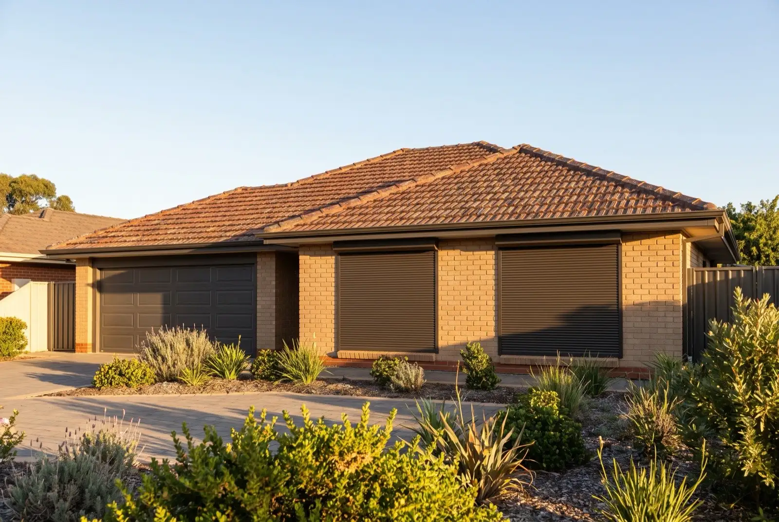 Illustration of dark bronze roller shutters on a 1990s brick house