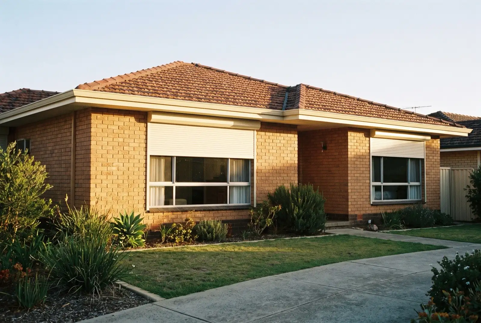 Illustration of off-white roller shutters on a 1970s brick house