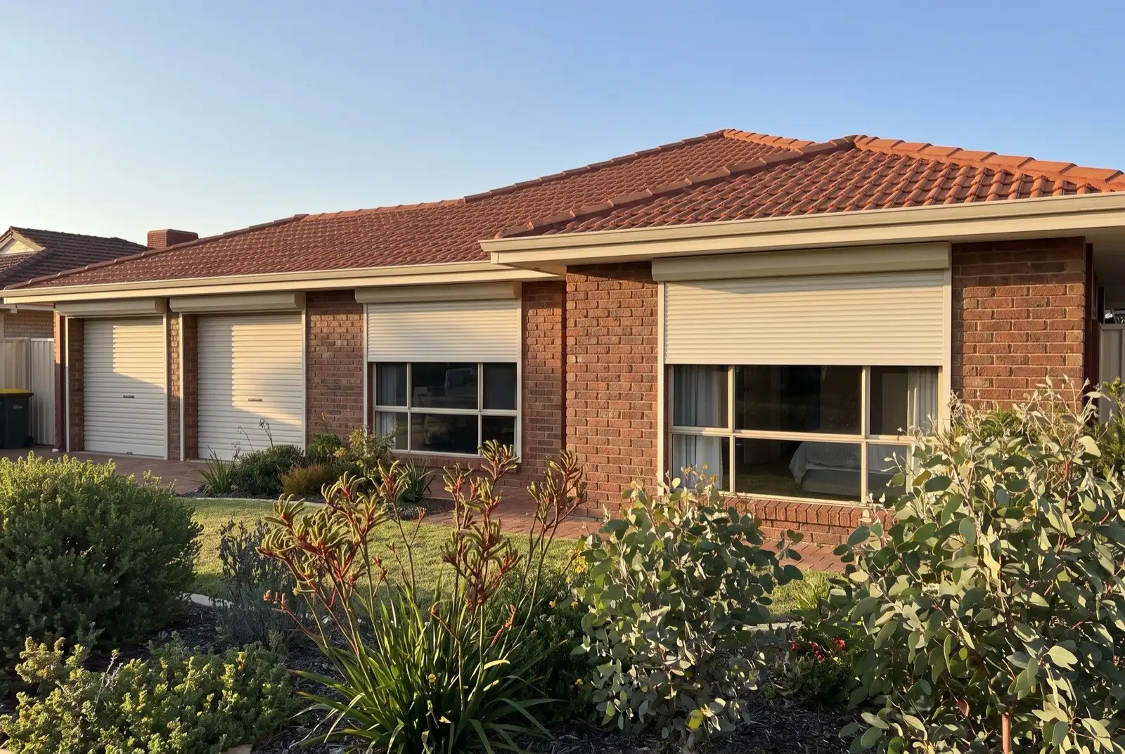 Illustration of off-white roller shutters on a 1990s brick house