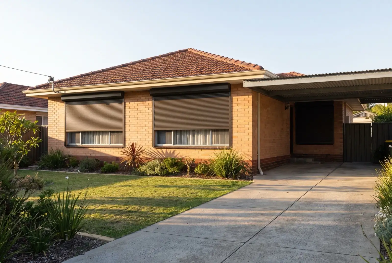 Illustration of dark bronze roller shutters on a 1950s brick and tile house