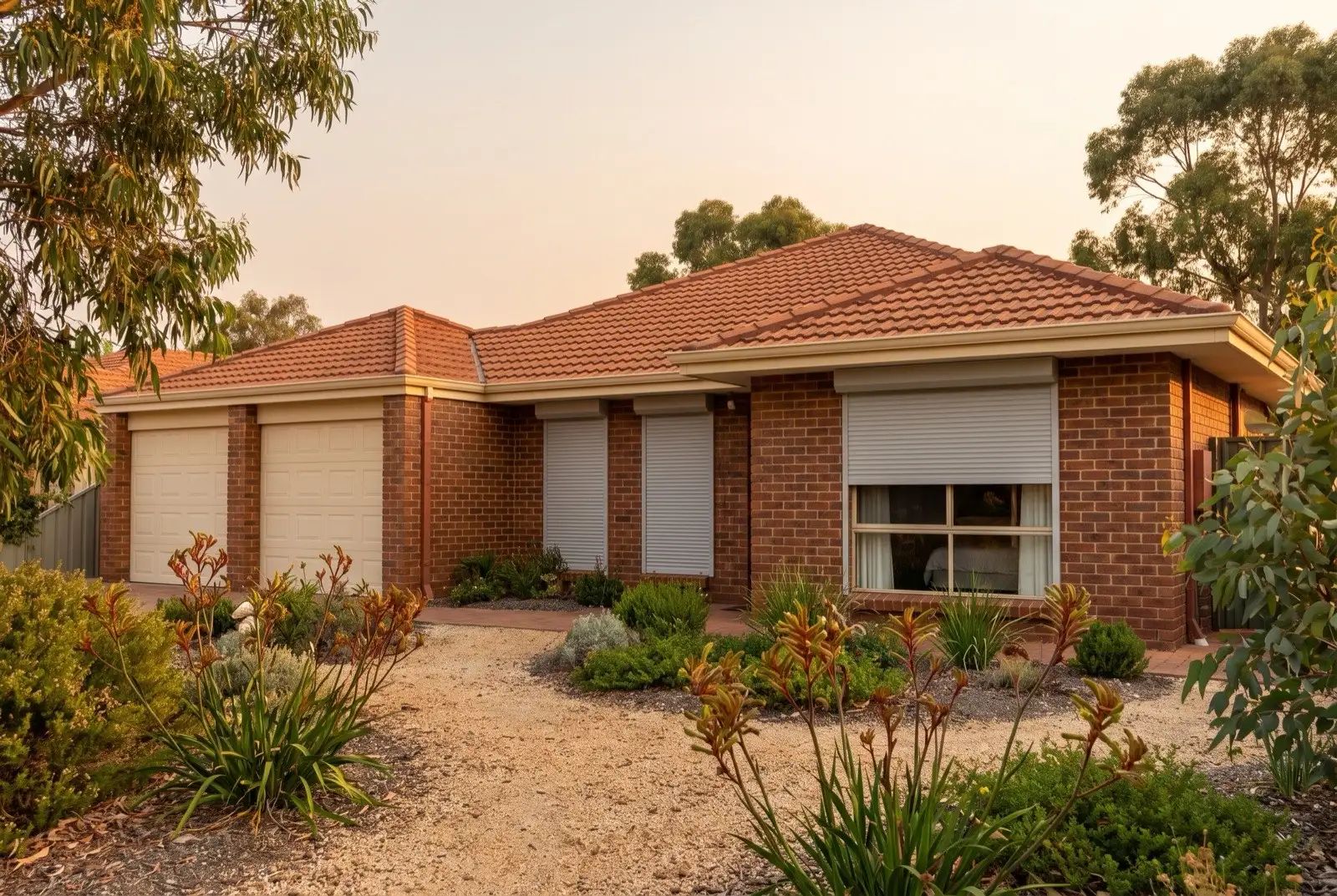 Illustration of pale grey roller shutters on a 1990s brick house
