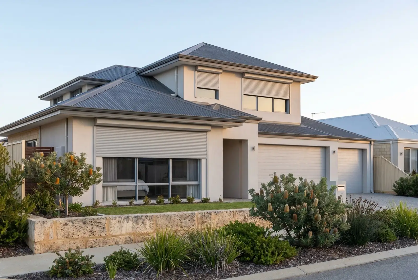 Illustration of mid grey roller shutters on a modern two storey house near the coast