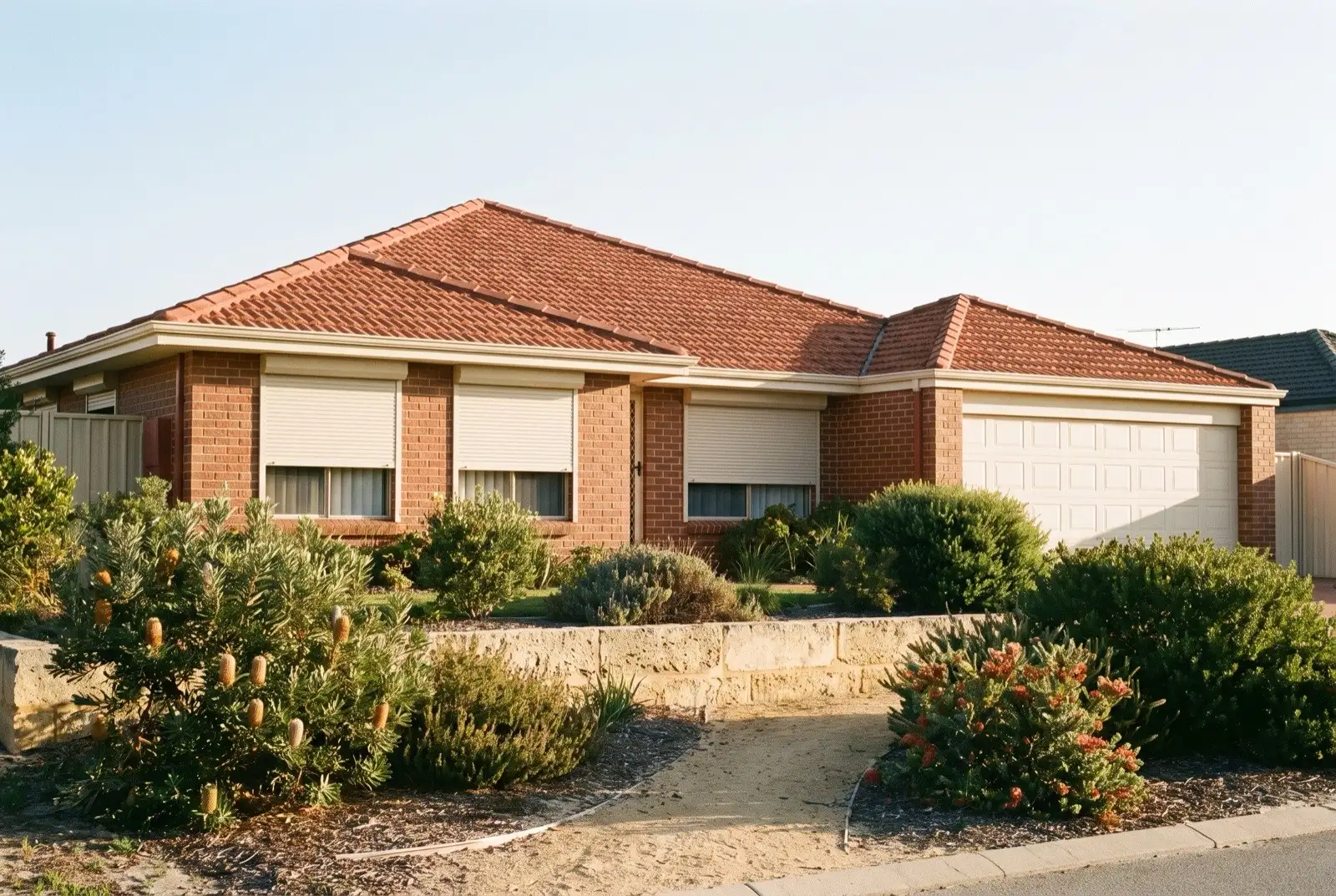 Illustration of off-white roller shutters on a 1990s brick house near the coast