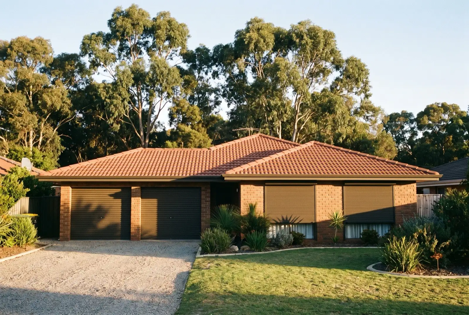 Illustration of dark bronze roller shutters on a 1990s brick house on a bush block