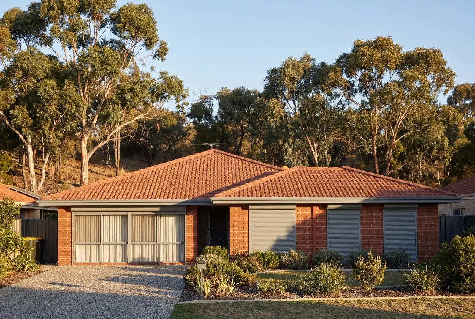 Illustration of mid grey roller shutters on a 1990s brick house on a bush block