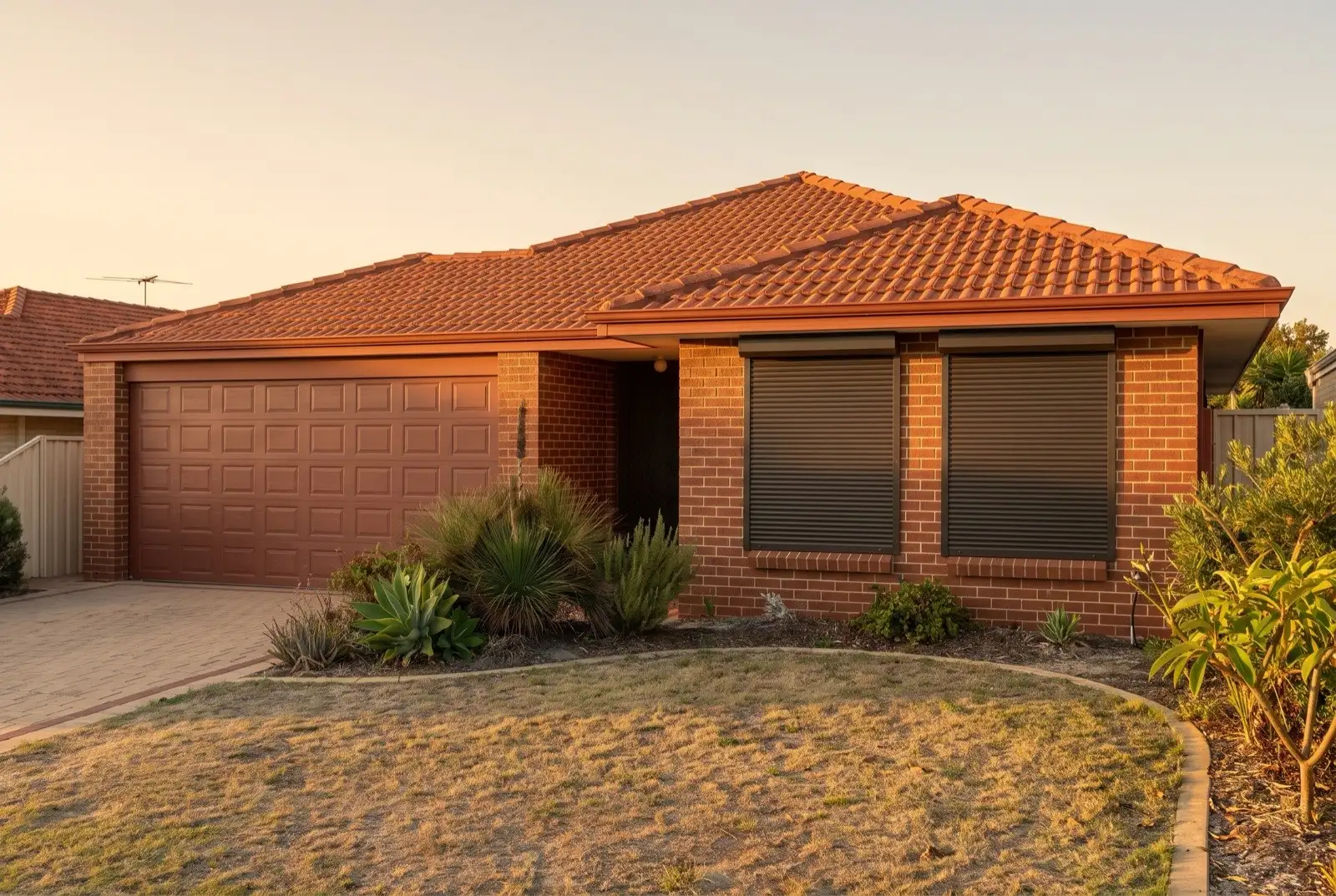 Illustration of dark bronze roller shutters on a 1990s brick house