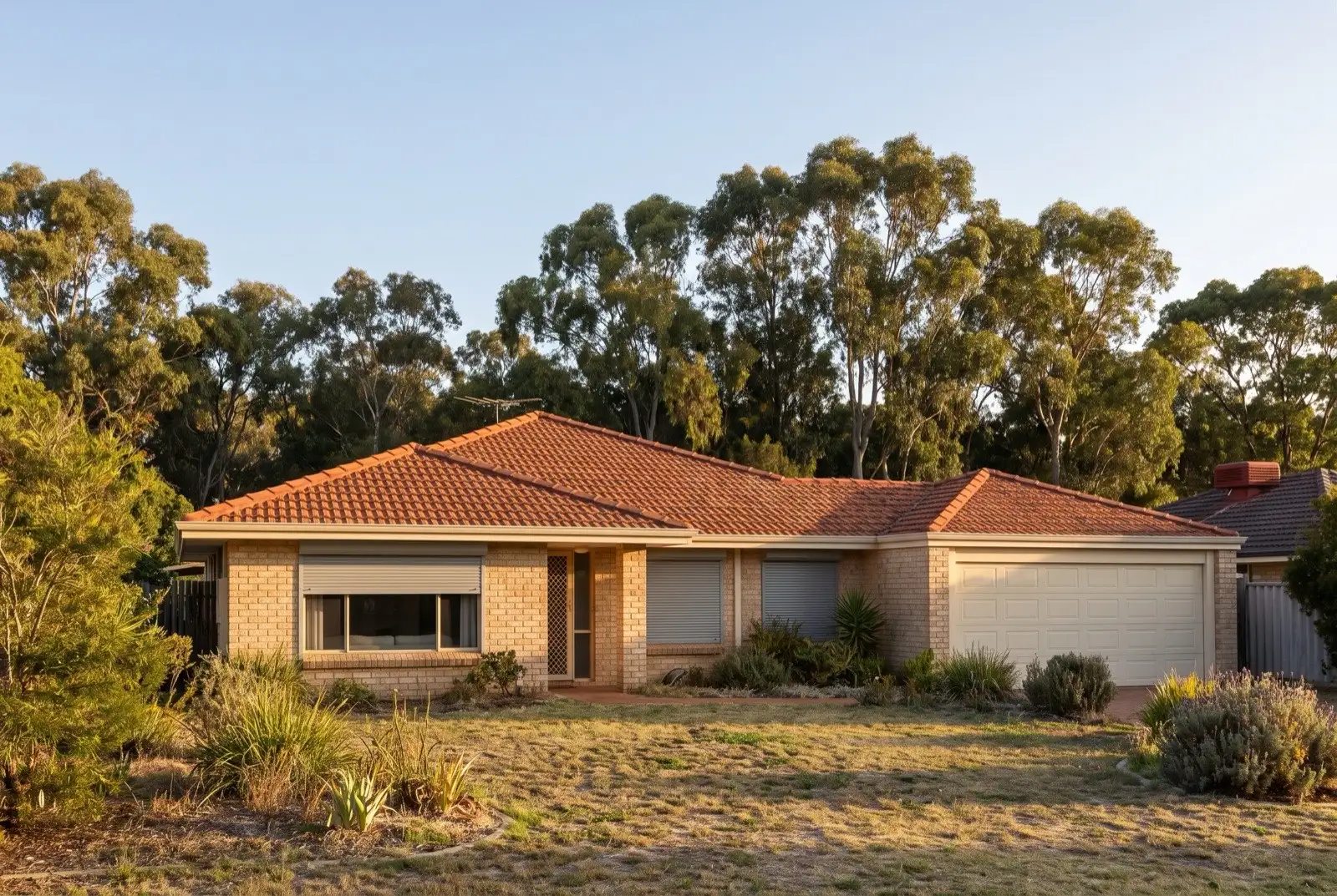 Illustration of mid grey roller shutters on a 1990s brick house on a bush block