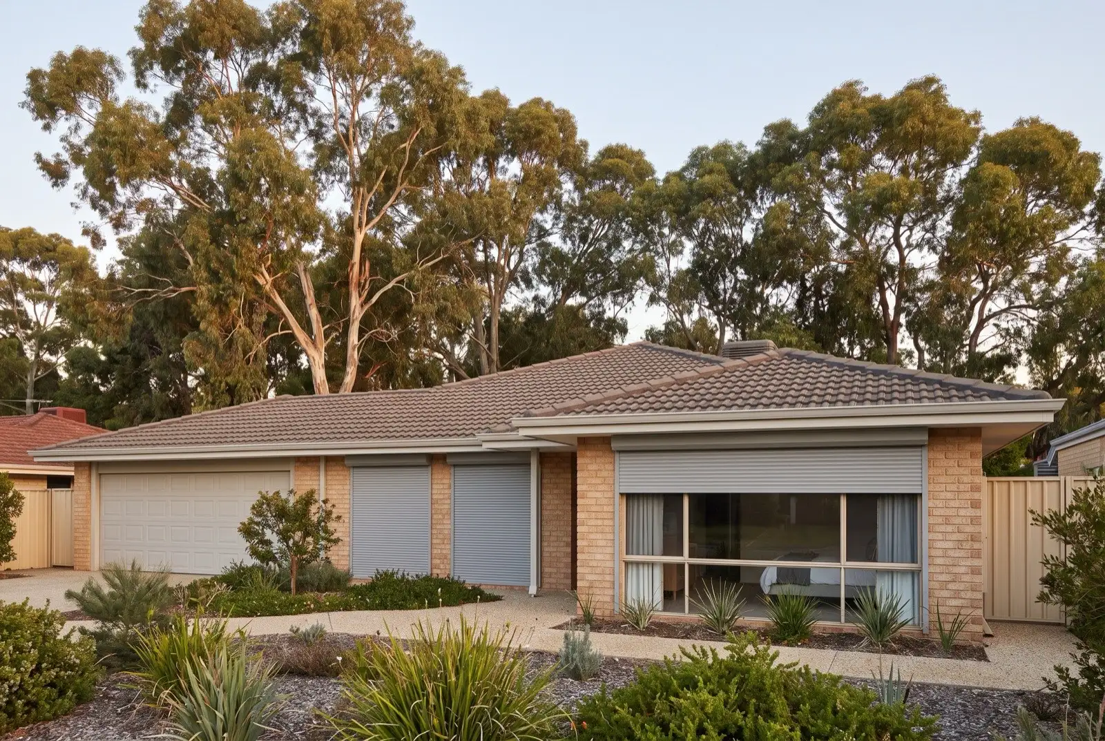 Illustration of mid grey roller shutters on a 1990s brick house on a bush block