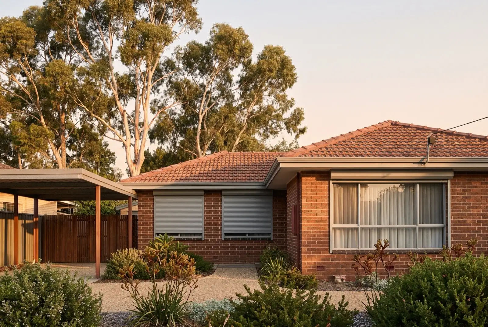 Illustration of mid grey roller shutters on a 1950s brick and tile house on a bush block
