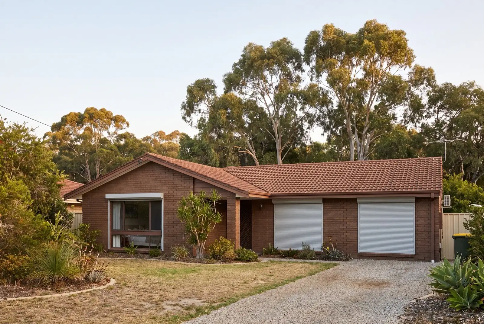 Illustration of pale grey roller shutters on a 1970s brick house on a bush block