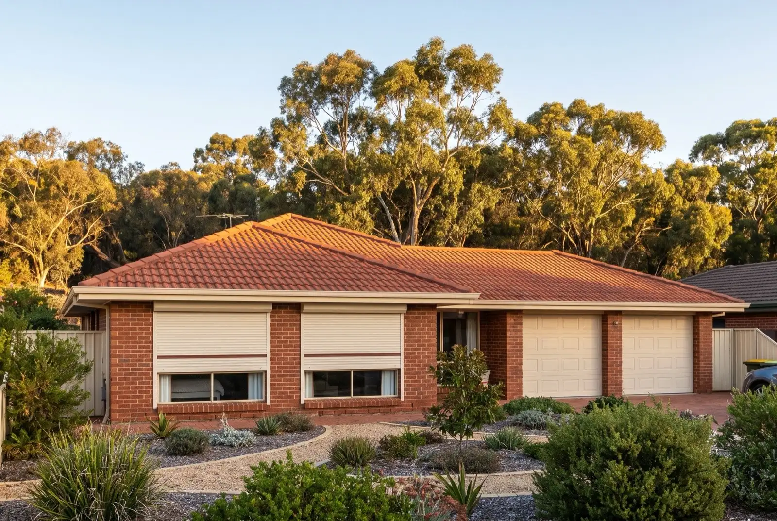 Illustration of off-white roller shutters on a 1990s brick house on a bush block