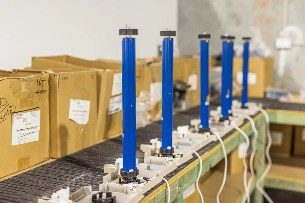 Row of tubular roller shutter motors lined up on the assembly bench