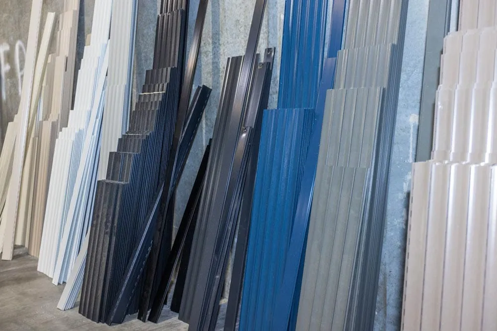 Stacks of roller shutter slats in white, grey, blue and charcoal