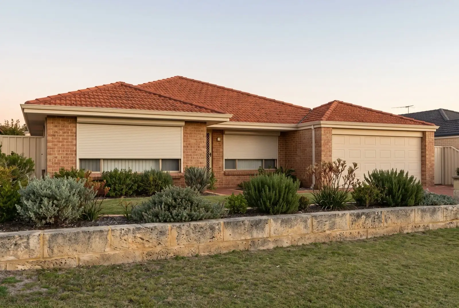 Illustration of off-white roller shutters on a 1990s brick house near the coast