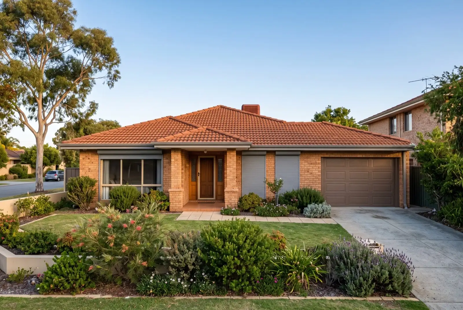 Illustration of mid grey roller shutters on a 1990s brick house