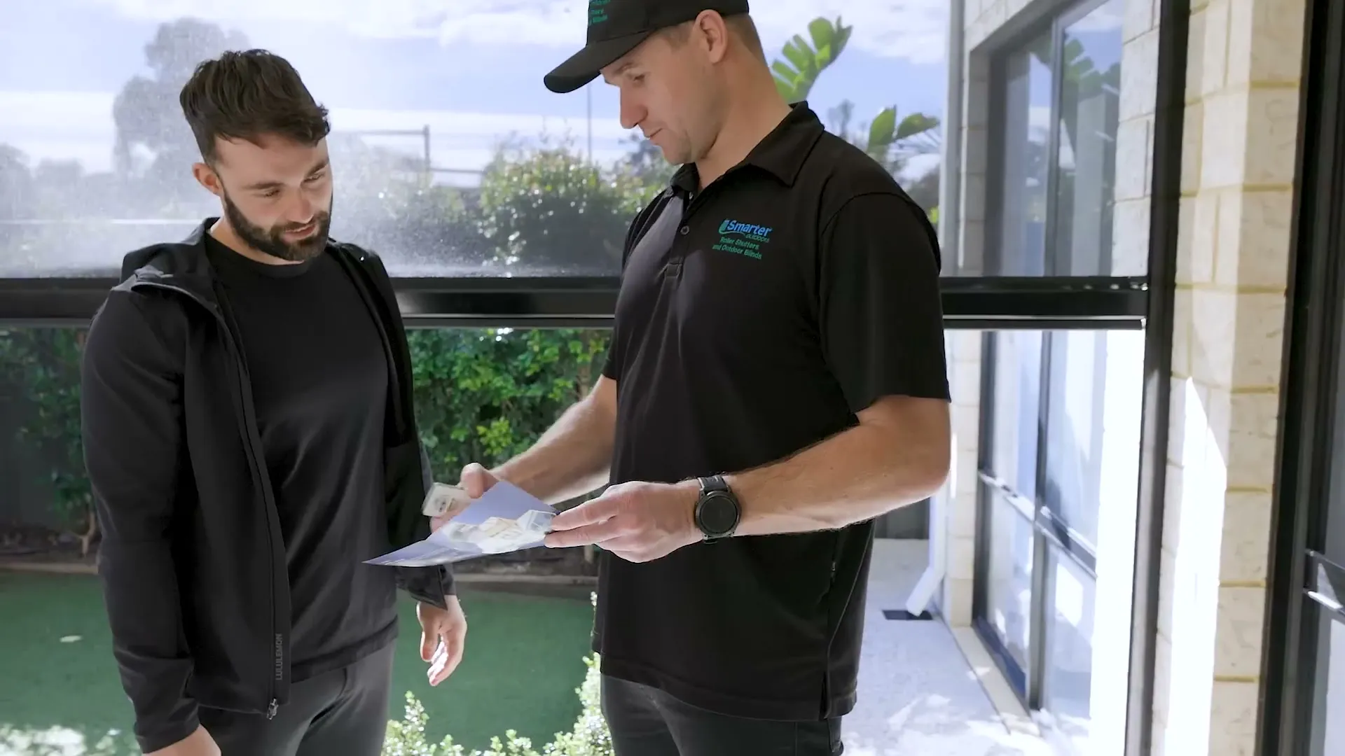 Smarter Outdoors consultant talking a customer through their new outdoor blinds