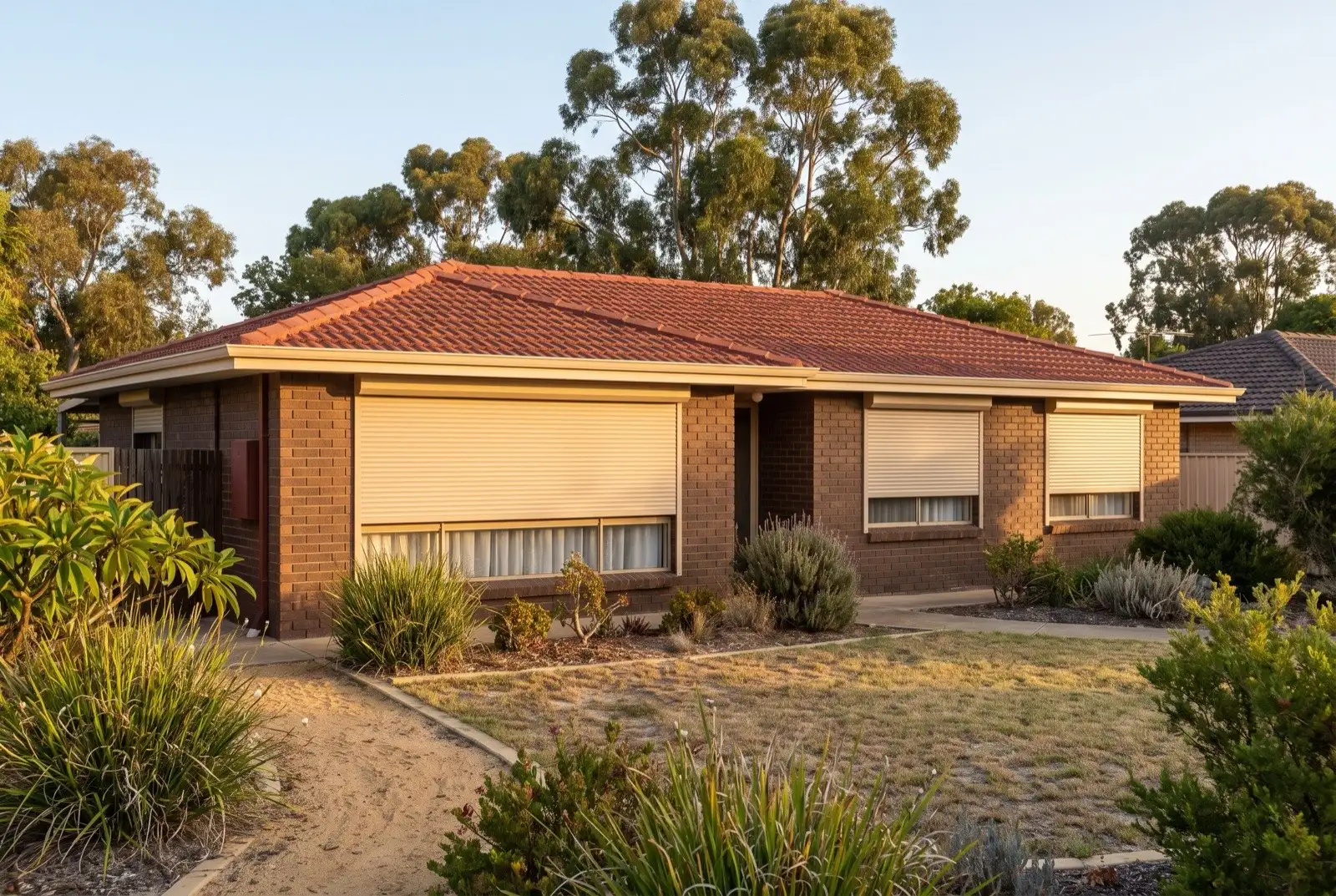 Illustration of warm beige roller shutters on a 1970s brick house on a bush block