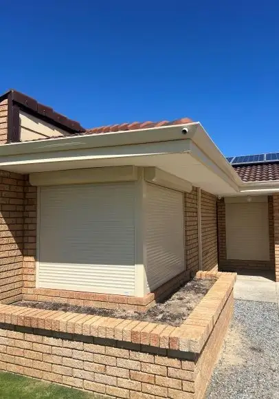 Cream roller shutters on a brick home in Alexander Heights