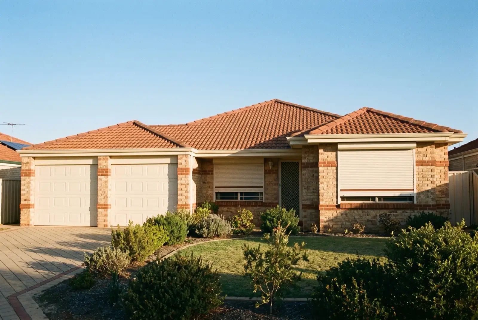 Illustration of off-white roller shutters on a 1990s brick house